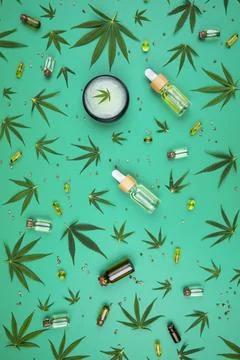 Flat lay composition of marijuana and hemp seeds on green color paper backg.. Stock Photos