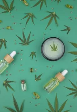 Flat lay composition of marijuana and hemp seeds on green color paper backg.. Stock Photos