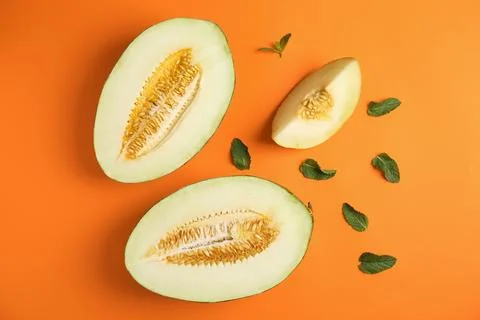 Flat lay composition with melon and mint leaves on color background Stock Photos
