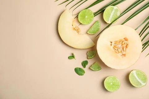 Flat lay composition with melon, lime and space for text on color background Stock Photos