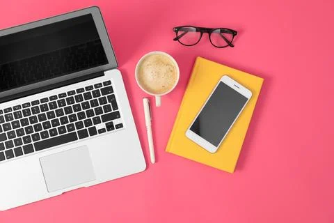 Flat lay composition with modern devices and office tools on pink background Stock Photos