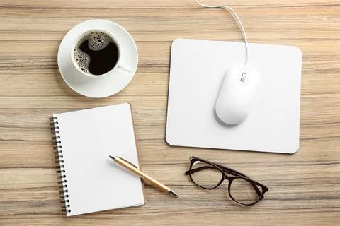 Flat lay composition with mouse and cup of coffee on wooden table Stock Photos