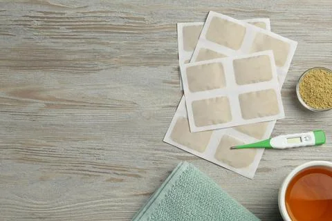 Flat lay composition with mustard plasters on wooden table. Space for text Stock Photos
