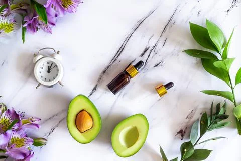 Flat lay composition of natural cosmetics for face skin care, serum and avocado Stock Photos