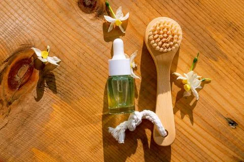A flat lay composition of natural essence oil bottle and brush on a natural Stock Photos