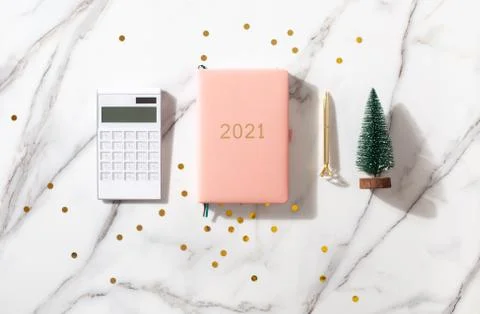 Flat lay composition with New Year's decoration, coral colored 2021 diary book Stock Photos