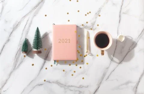 Flat lay composition with New Year's decoration, coral colored 2021 diary book Stock Photos