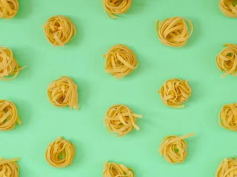 Flat lay composition with noodles raw on color background green. Stock Photos