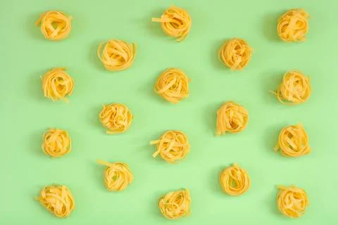 Flat lay composition with noodles raw on color background green. Stock Photos