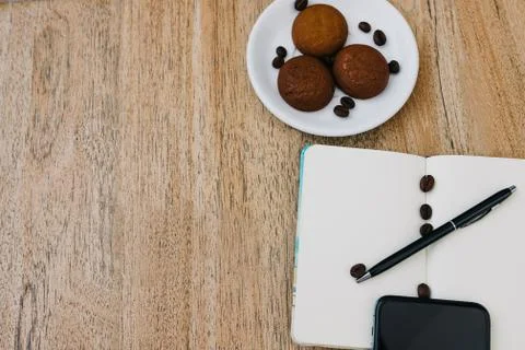 Flat lay composition with notepad, cup of coffee and breakfast cookies Stock Photos