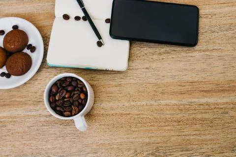 Flat lay composition with notepad, smartphone, cup of coffee and breakfast Stock Photos
