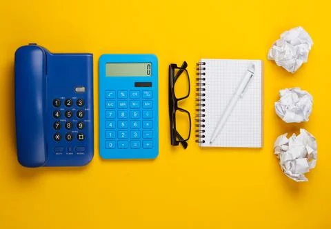 Flat lay composition of office supplies on a yellow background. Top view Stock Photos