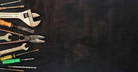 Flat lay composition with old tools on a wooden background. Top view Stock Photos