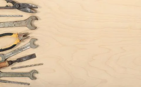 Flat lay composition with old tools on a light wooden background Stock Photos