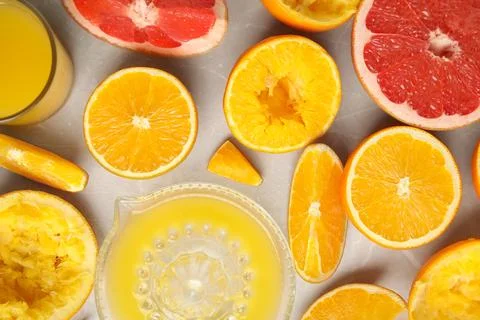 Flat lay composition with oranges and squeezer on light table Stock Photos