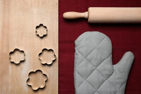 Flat lay composition with oven glove and kitchenware on wooden table Stock Photos