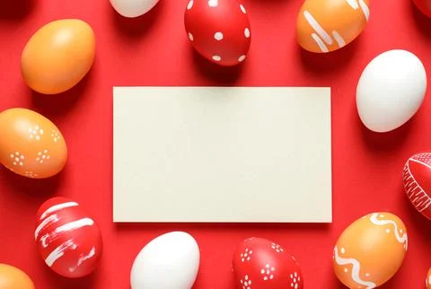 Flat lay composition of painted Easter eggs and card on color background, spa Stock Photos