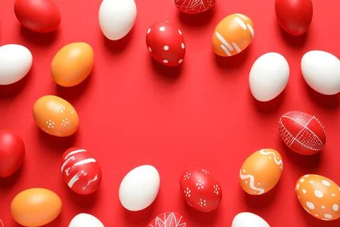 Flat lay composition with painted Easter eggs on color background, space for  Stock Photos