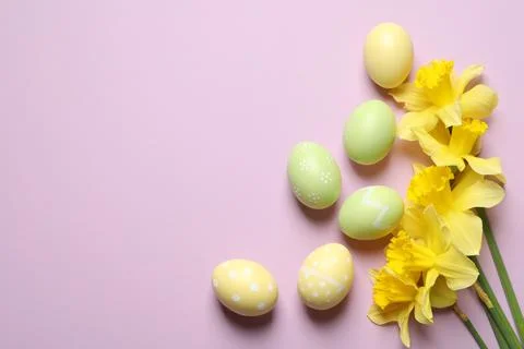 Flat lay composition of painted Easter eggs and flowers on color background,  Stock Photos