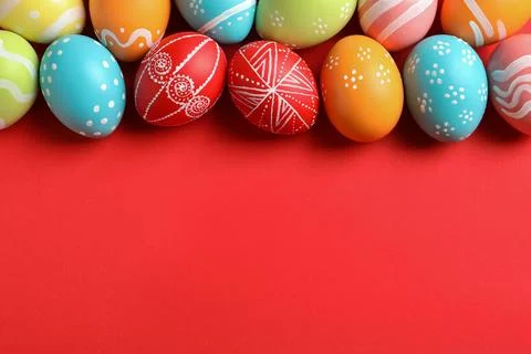 Flat lay composition of painted Easter eggs on color background, space for te Stock Photos