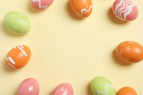 Flat lay composition of painted Easter eggs on color background, space for te Stock Photos