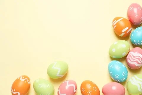 Flat lay composition of painted Easter eggs on color background, space for te Stock Photos