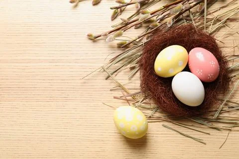Flat lay composition with painted Easter eggs on wooden table, space for text Stock Photos
