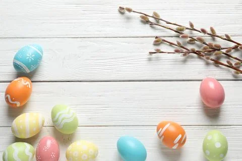 Flat lay composition with painted Easter eggs on wooden background, space for Stock Photos