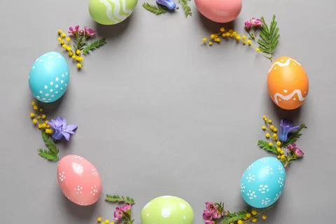 Flat lay composition of painted Easter eggs and flowers on color background,  Stock Photos