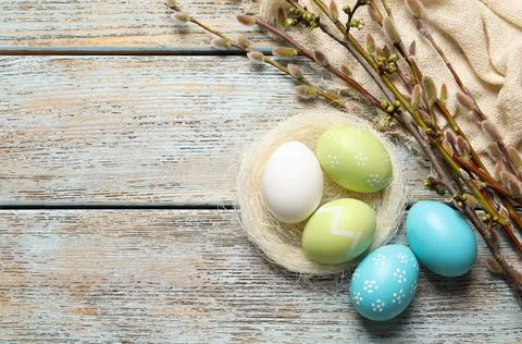 Flat lay composition with painted Easter eggs on wooden table, space for text Stock Photos