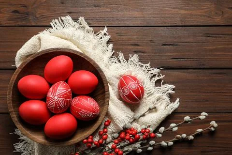 Flat lay composition with painted red Easter eggs on wooden table, space for  Stock Photos