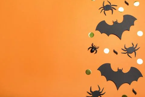 Flat lay composition with paper bats and spiders on orange background, space  Stock Photos