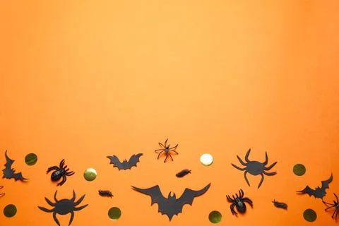 Flat lay composition with paper bats and spiders on orange background, space  Stock Photos
