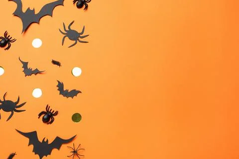 Flat lay composition with paper bats and spiders on orange background, space  Stock Photos