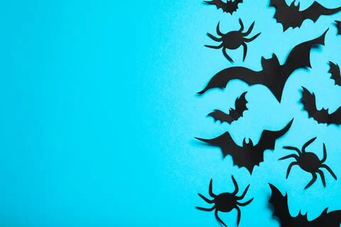Flat lay composition with paper bats and spiders on light blue background, sp Stock Photos