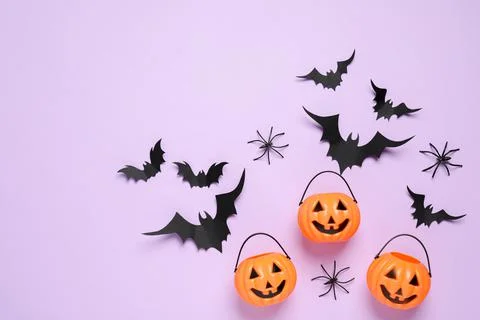 Flat lay composition with paper bats, plastic pumpkin baskets and spiders on  Stock Photos