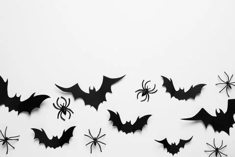Flat lay composition with paper bats and spiders on white background, space f Stock Photos