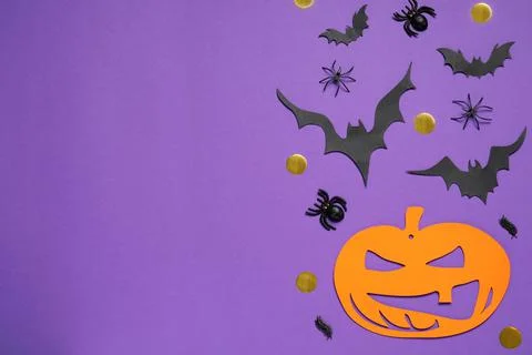 Flat lay composition with paper bats, pumpkin and spiders on purple backgroun Stock Photos