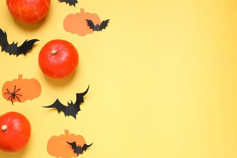 Flat lay composition with paper bats, pumpkins and spider on yellow backgroun Stock Photos