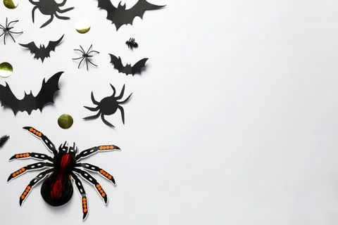 Flat lay composition with paper bats and spiders on white background, space f Stock Photos
