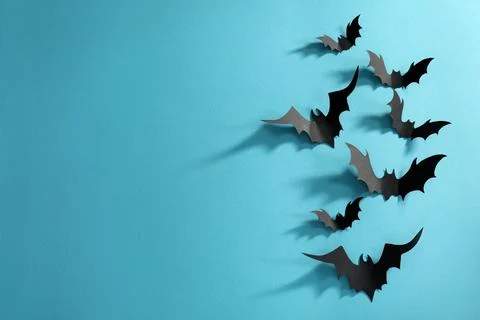 Flat lay composition paper bats on light blue background, space for text. Hal Stock Photos