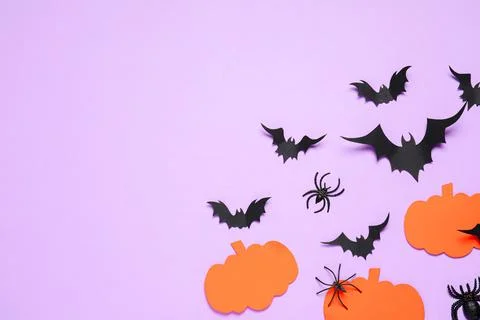 Flat lay composition with paper bats, spiders and pumpkins on light violet ba Stock Photos
