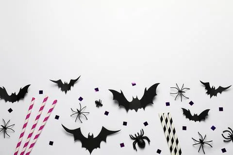 Flat lay composition with paper bats, spiders and straws on white background, Stock Photos