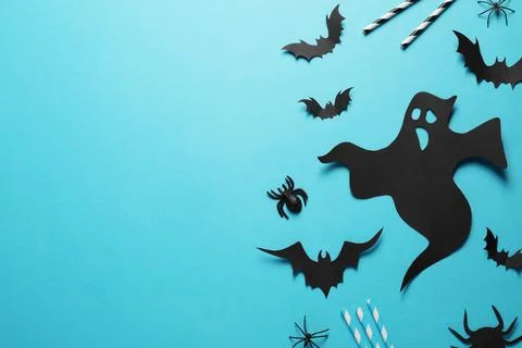 Flat lay composition with paper ghost and bats on light blue background, spac Stock Photos