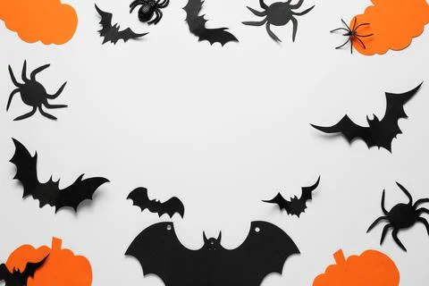 Flat lay composition with paper pumpkins, bats and spiders on white backgroun Stock Photos