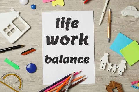 Flat lay composition with paper sheet on light wooden table. Life work balanc Stock Photos