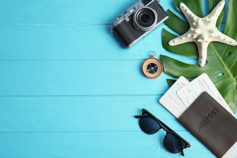 Flat lay composition with passport and camera on color wooden background, spa Foto stock