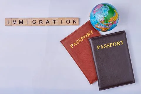 Flat lay composition with passports, globe and inscription immigration written Stock Photos