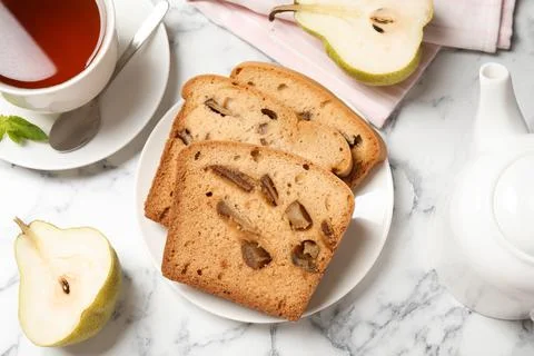 Flat lay composition with pear bread on white marble table. Homemade cake Stock Photos