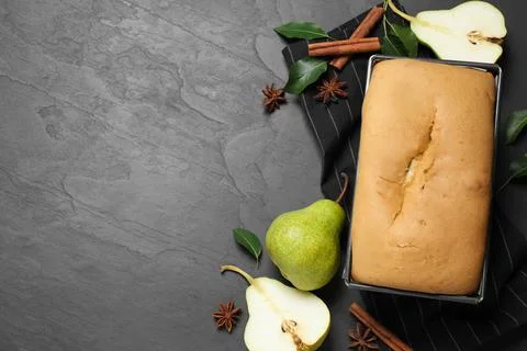 Flat lay composition with pear bread on black slate table, space for text. Ho Stock Photos